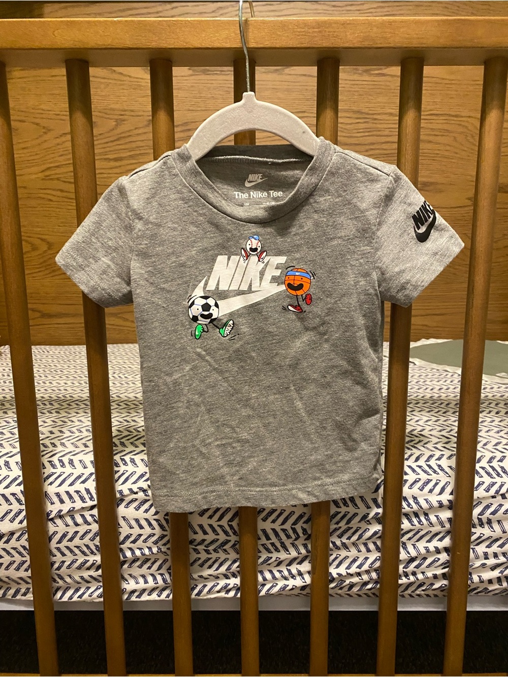 Nike Gray Short-Sleeve Kids Sports Tee with Playful Ball Graphics